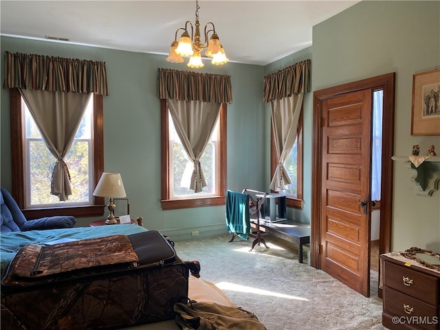 bedroom with an inviting chandelier, carpet floors, and multiple windows