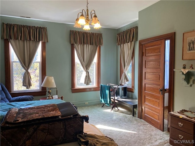 bedroom featuring a chandelier, visible vents, multiple windows, and carpet floors