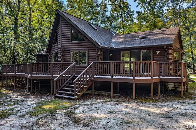 back of property featuring a wooden deck