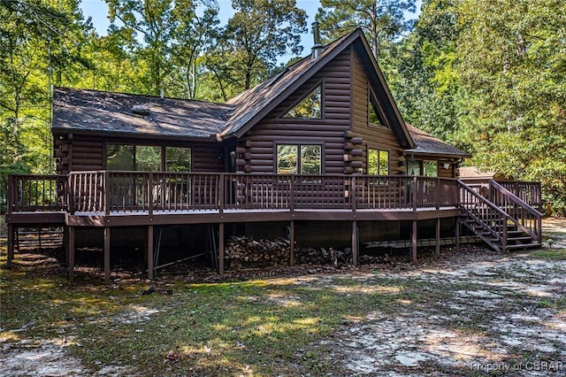 rear view of house featuring a wooden deck