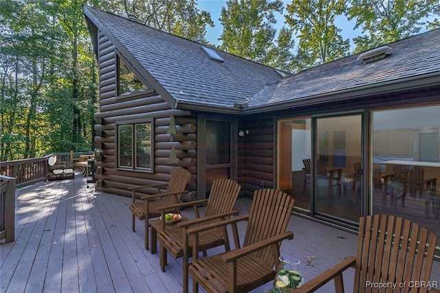 wooden terrace with an outdoor living space