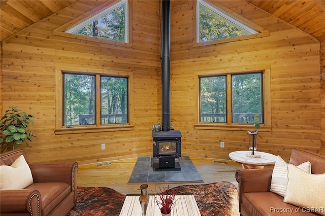 living room with wooden ceiling, high vaulted ceiling, and plenty of natural light