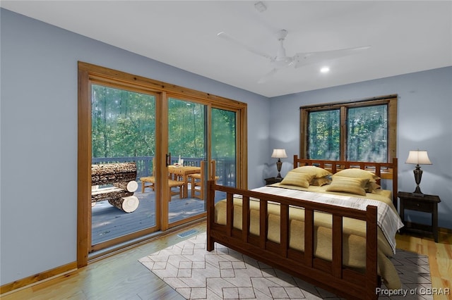 bedroom featuring access to outside, multiple windows, light hardwood / wood-style floors, and ceiling fan