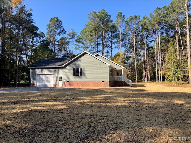 view of property exterior with covered porch and a garage