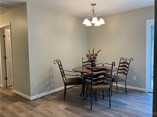 dining room with plenty of natural light and dark hardwood / wood-style flooring