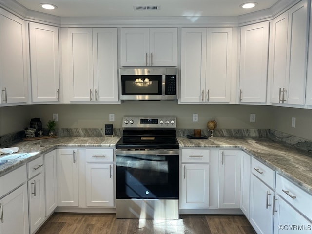 kitchen featuring white cabinets, stainless steel appliances, and dark hardwood / wood-style flooring