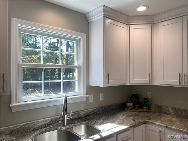 kitchen with sink and white cabinetry