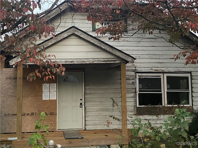 view of exterior entry with a wooden deck