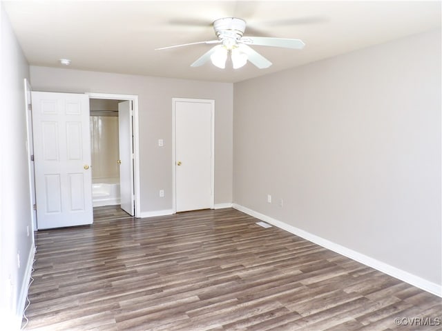 unfurnished bedroom featuring ceiling fan and dark hardwood / wood-style flooring