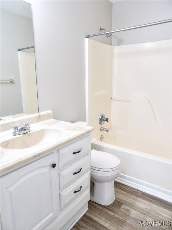 full bathroom featuring vanity, hardwood / wood-style flooring, toilet, and shower / bathtub combination