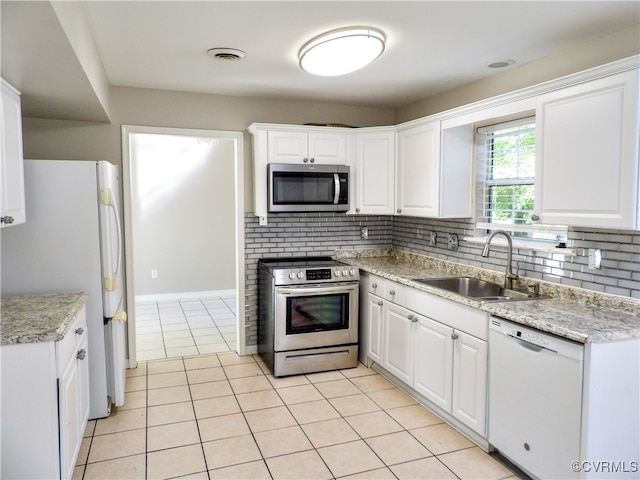 kitchen with white cabinetry, stainless steel appliances, decorative backsplash, and sink