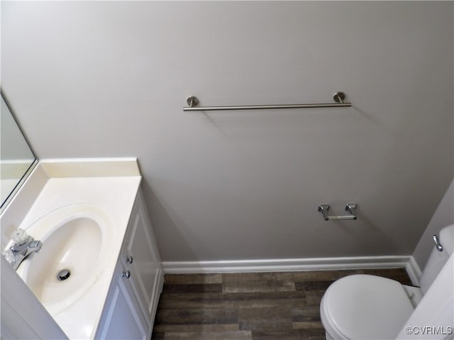 bathroom featuring vanity, toilet, and wood-type flooring