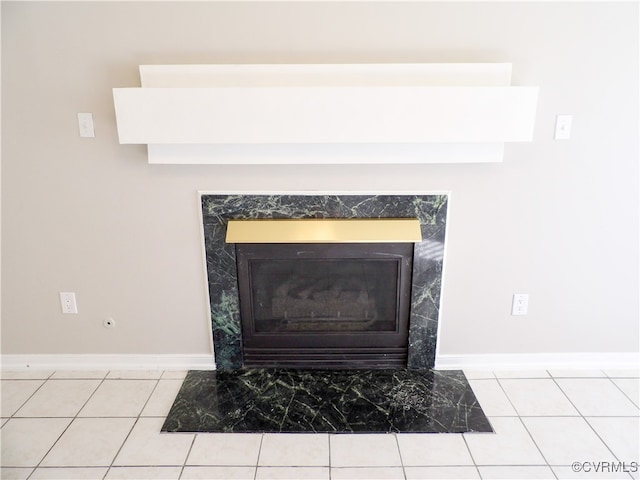 room details with tile patterned floors and a tile fireplace