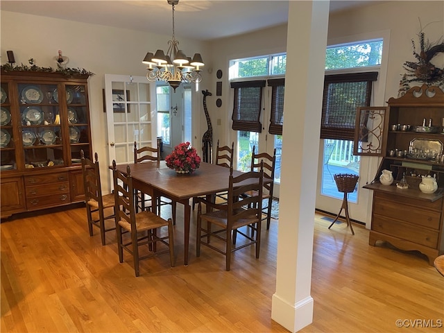 dining area featuring a chandelier and light hardwood / wood-style flooring