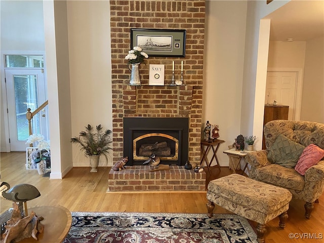 sitting room featuring a fireplace and wood-type flooring