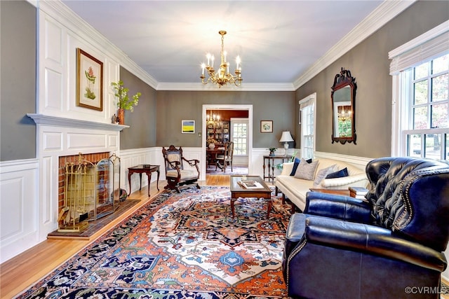 living room with ornamental molding, plenty of natural light, and wood-type flooring