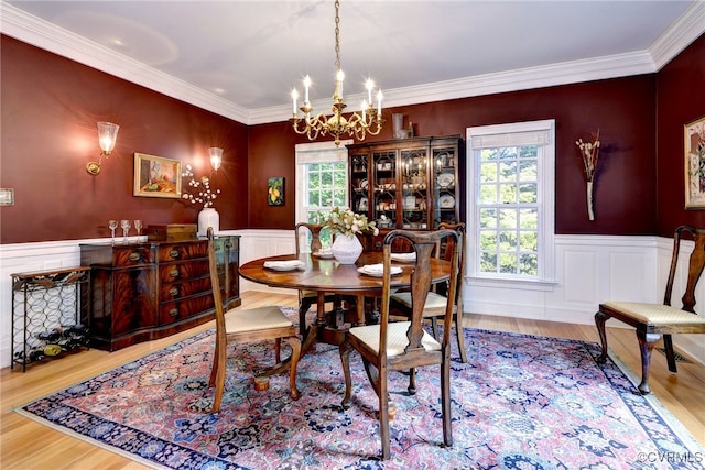 dining space featuring hardwood / wood-style floors, a notable chandelier, and crown molding