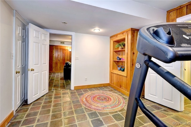 workout room with wooden walls