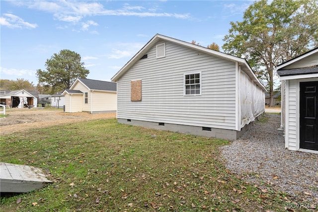 view of side of home featuring a yard