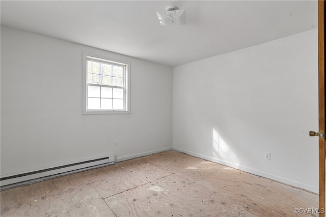 unfurnished room with a baseboard heating unit