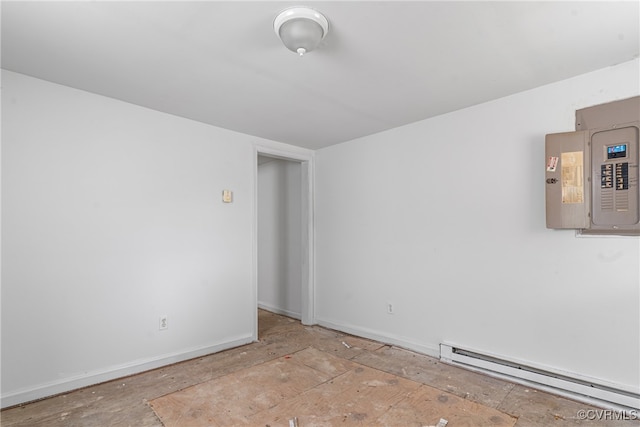 empty room with electric panel and a baseboard heating unit