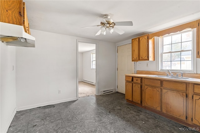 kitchen with baseboard heating, a wealth of natural light, and sink