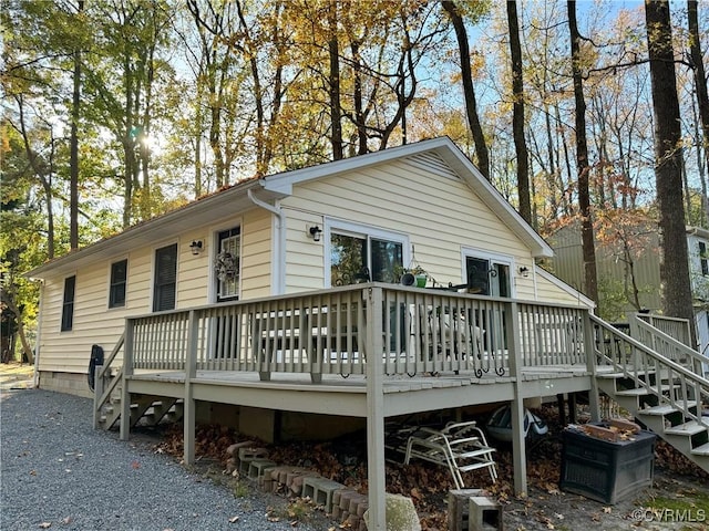 rear view of property featuring a deck