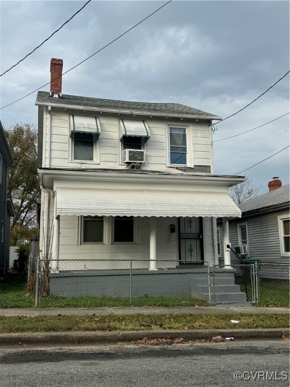 view of front facade with cooling unit and a porch