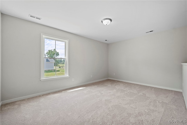 unfurnished room featuring light colored carpet