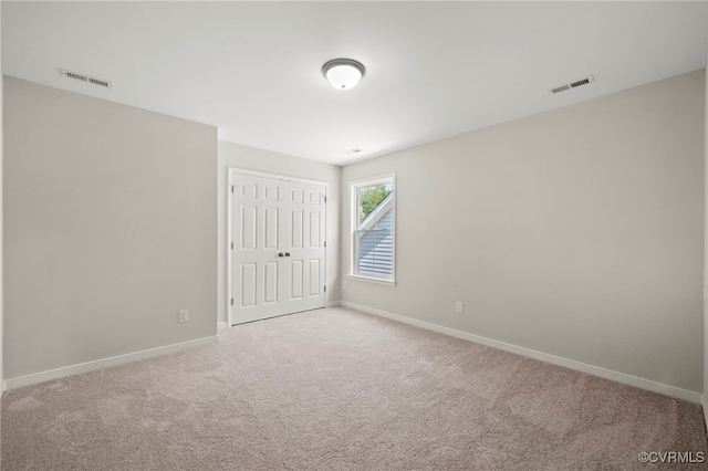 empty room with light colored carpet