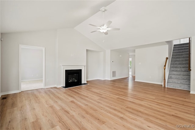 unfurnished living room featuring vaulted ceiling, light wood-type flooring, and ceiling fan