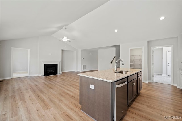 kitchen featuring lofted ceiling, sink, light hardwood / wood-style flooring, and dark brown cabinets