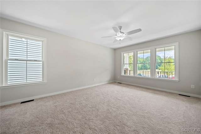 spare room featuring ceiling fan and carpet flooring