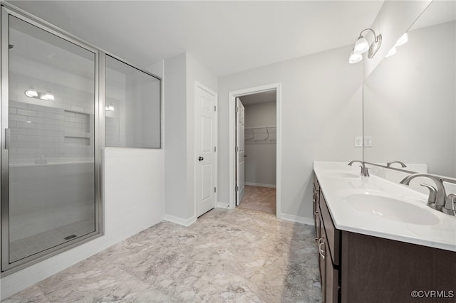 bathroom featuring vanity and a shower with shower door