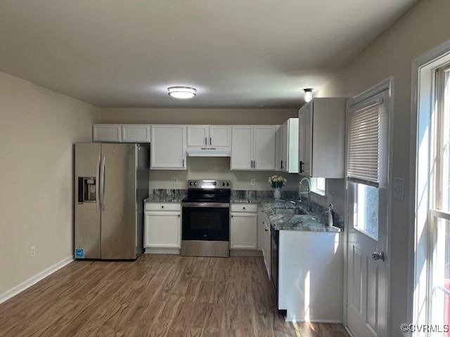 kitchen with white cabinets, appliances with stainless steel finishes, a wealth of natural light, and sink