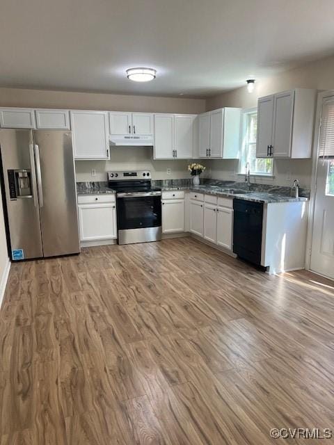 kitchen with white cabinets, light wood-type flooring, stainless steel appliances, and sink