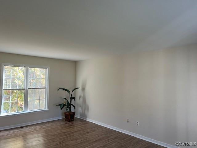 spare room featuring dark hardwood / wood-style flooring