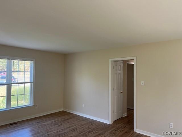 empty room featuring dark hardwood / wood-style flooring