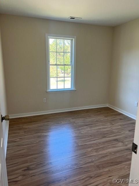 empty room featuring dark wood-type flooring