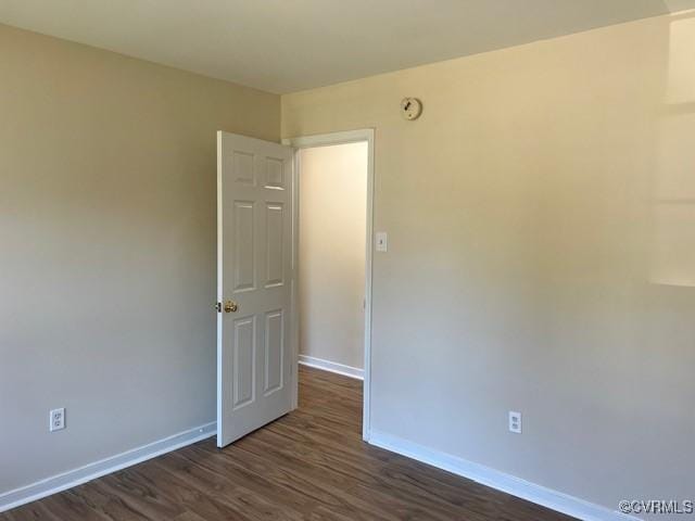 empty room with dark hardwood / wood-style floors