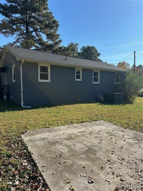 back of house with a lawn