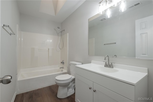 full bathroom featuring vanity, toilet, hardwood / wood-style flooring, and bathing tub / shower combination