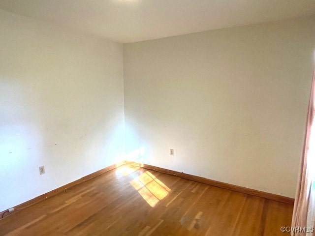 unfurnished room featuring hardwood / wood-style floors