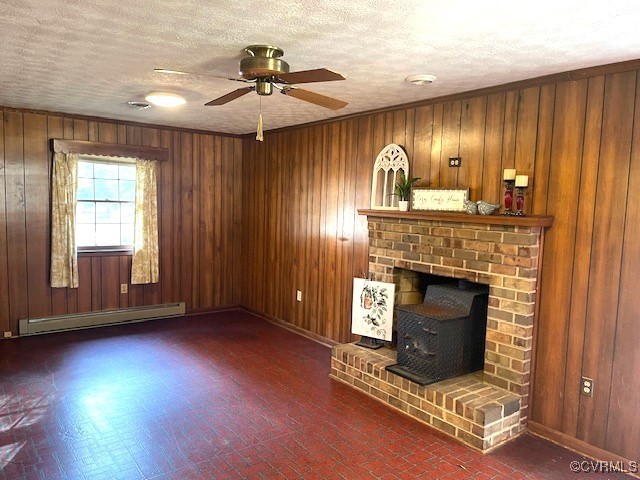 unfurnished living room featuring a baseboard radiator, ceiling fan, a textured ceiling, and wood walls