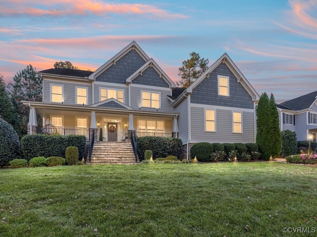 craftsman inspired home with a porch and a yard