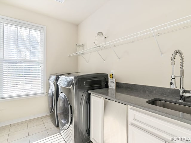 washroom featuring light tile patterned flooring, independent washer and dryer, and sink