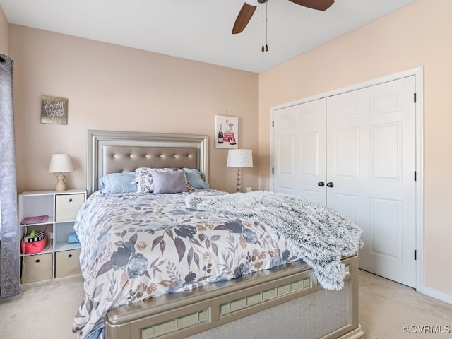 carpeted bedroom with ceiling fan and a closet