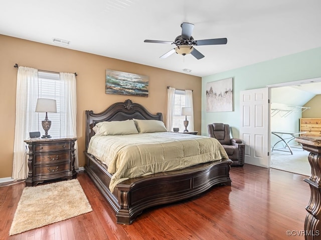 bedroom featuring multiple windows, ceiling fan, and dark hardwood / wood-style flooring