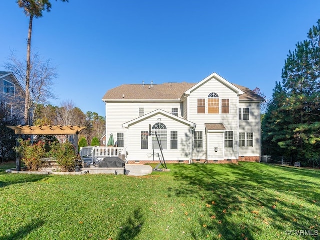 back of property with a yard and a deck