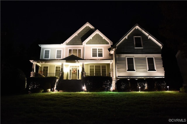 view of front of property with a lawn and a porch